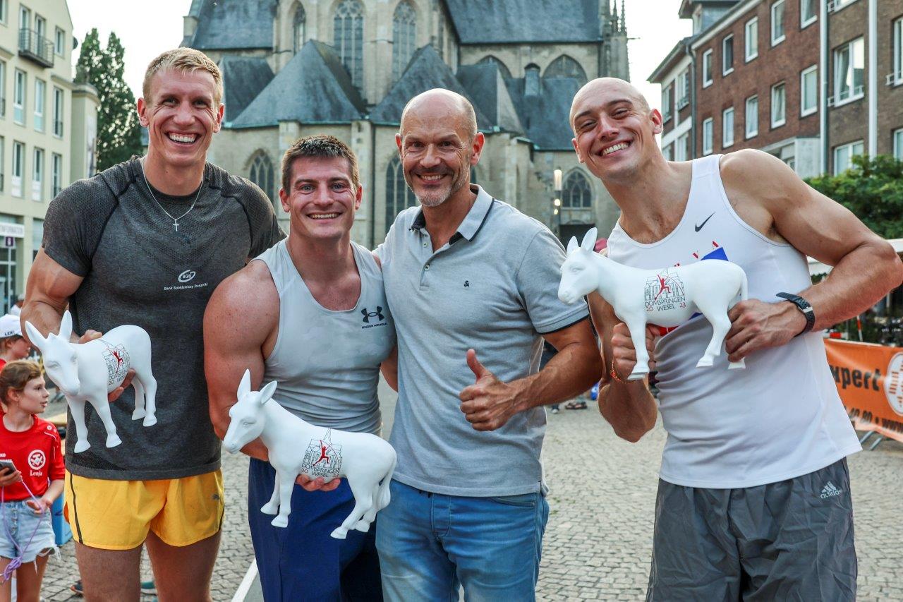 a group of men holding white plastic animals